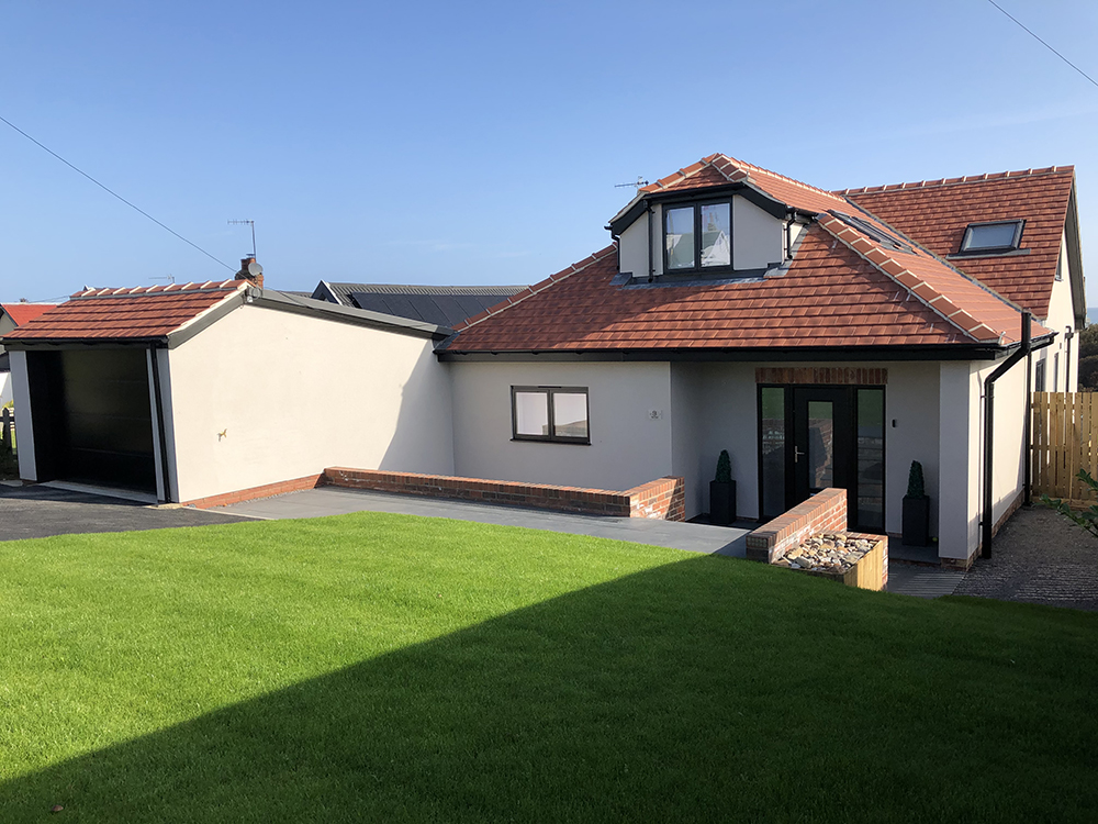 home renovation with blue sky and lawn